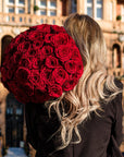 Sophisticated spherical arrangement of fresh red roses displayed from behind, highlighting the perfect dome formation and rich crimson petals of this luxury Valentine's bouquet - Amaranté London