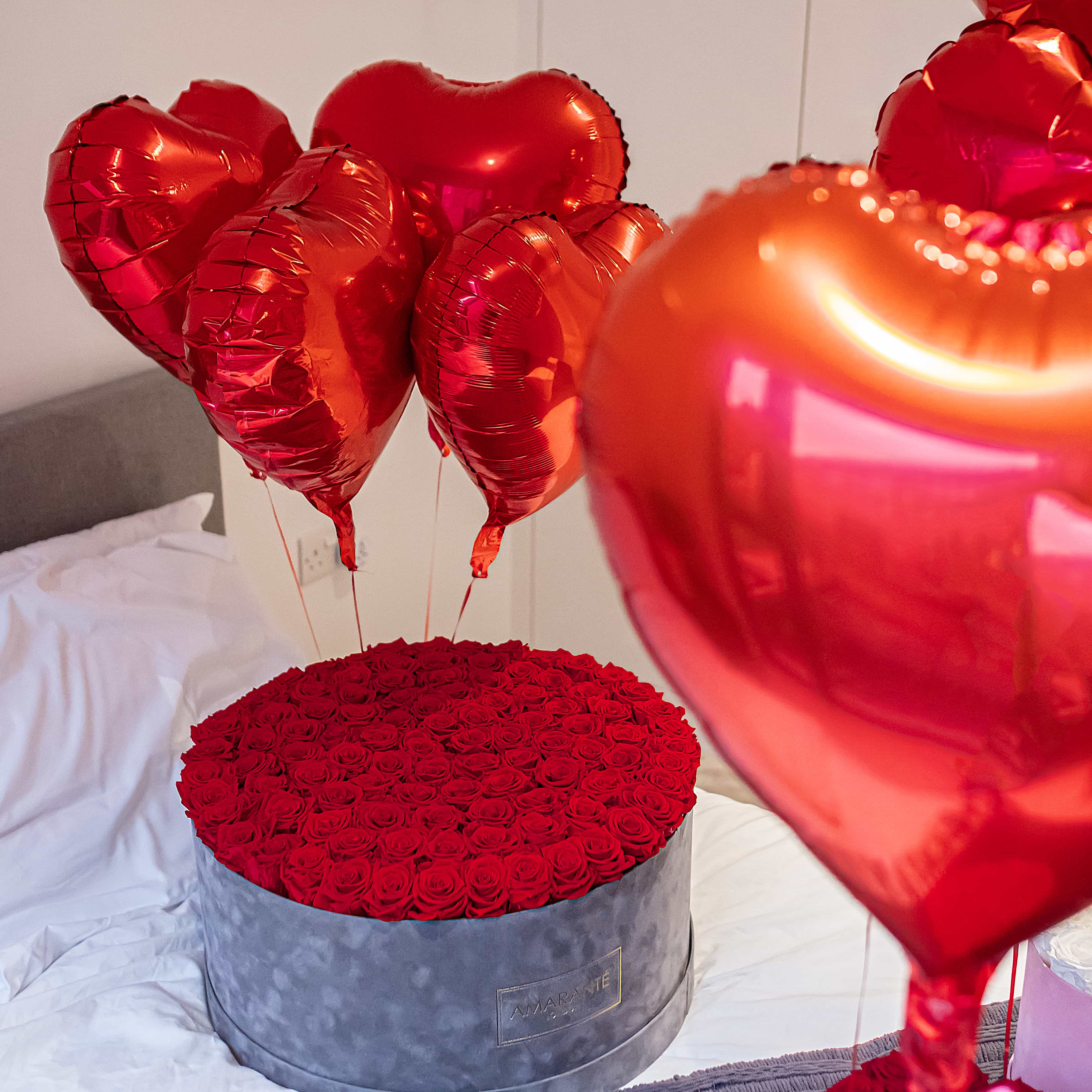A super deluxe round grey suede rose box that is ideal as a loving gift for a special anniversary celebration
