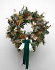 Christmas Wreath: Prague-inspired festive wreath in holiday greens with pine cones, with white and green ribbons - Amaranté London
