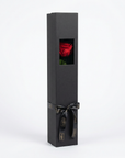Elegant charcoal grey luxury gift box with rectangular window revealing single preserved red rose, finished with sophisticated black ribbon and branded tags - Amarante London