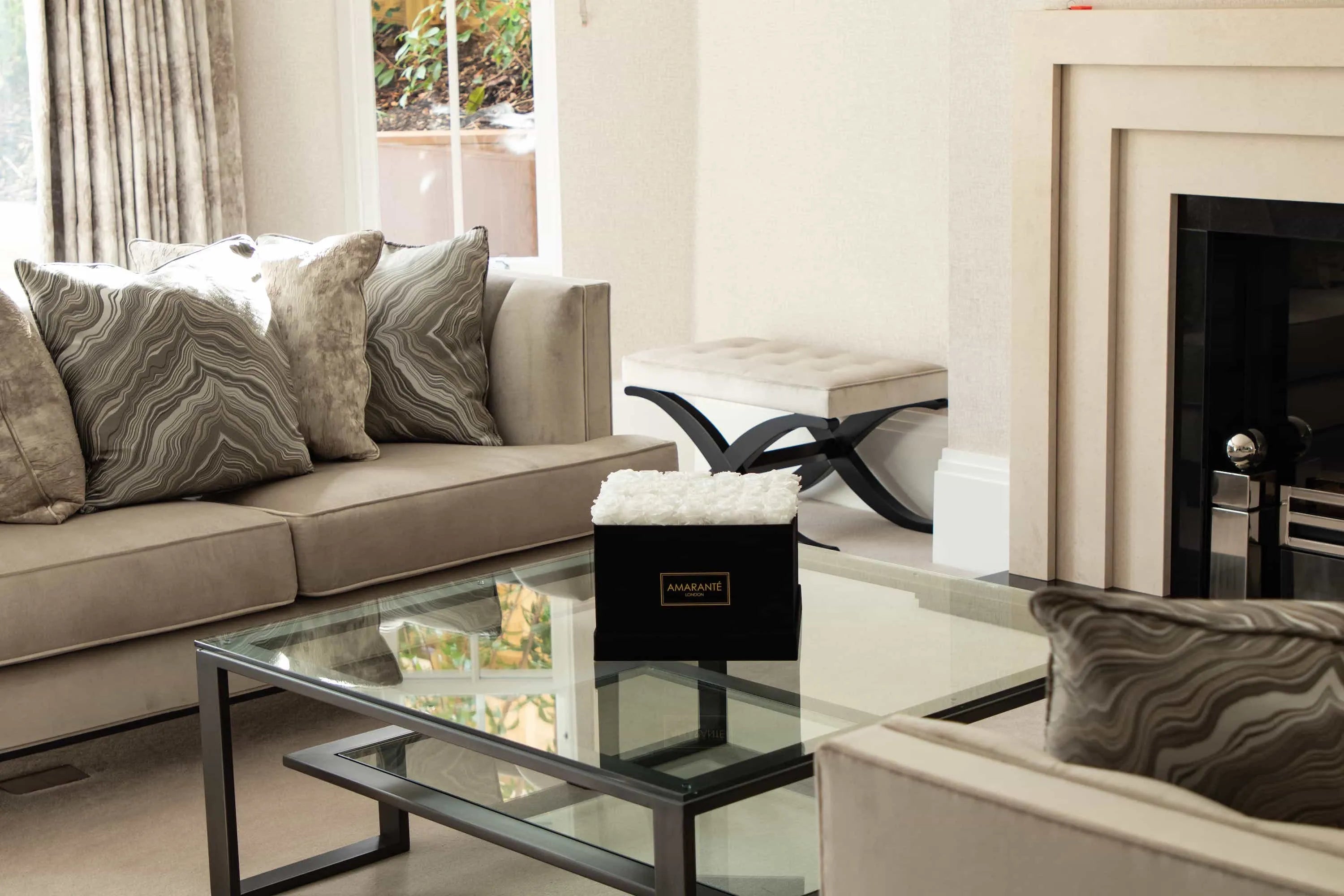 Experience timeless luxury with a black Suede rose box filled with white infinity roses - enhancing your living room with elegant, sustainable beauty
