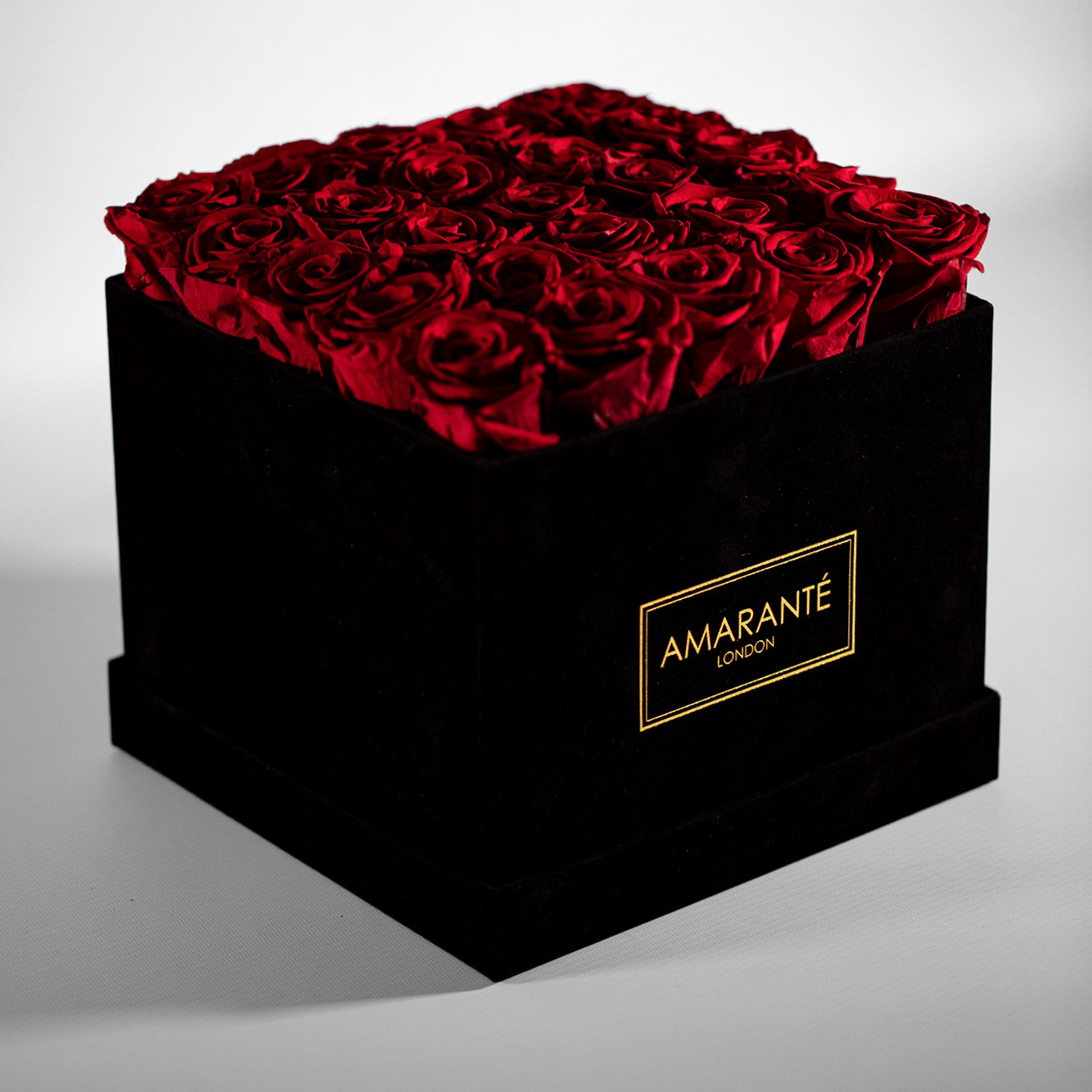 Magical red Roses featured in a stylish large square suede box 