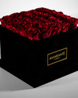 Magical red Roses featured in a stylish large square suede box