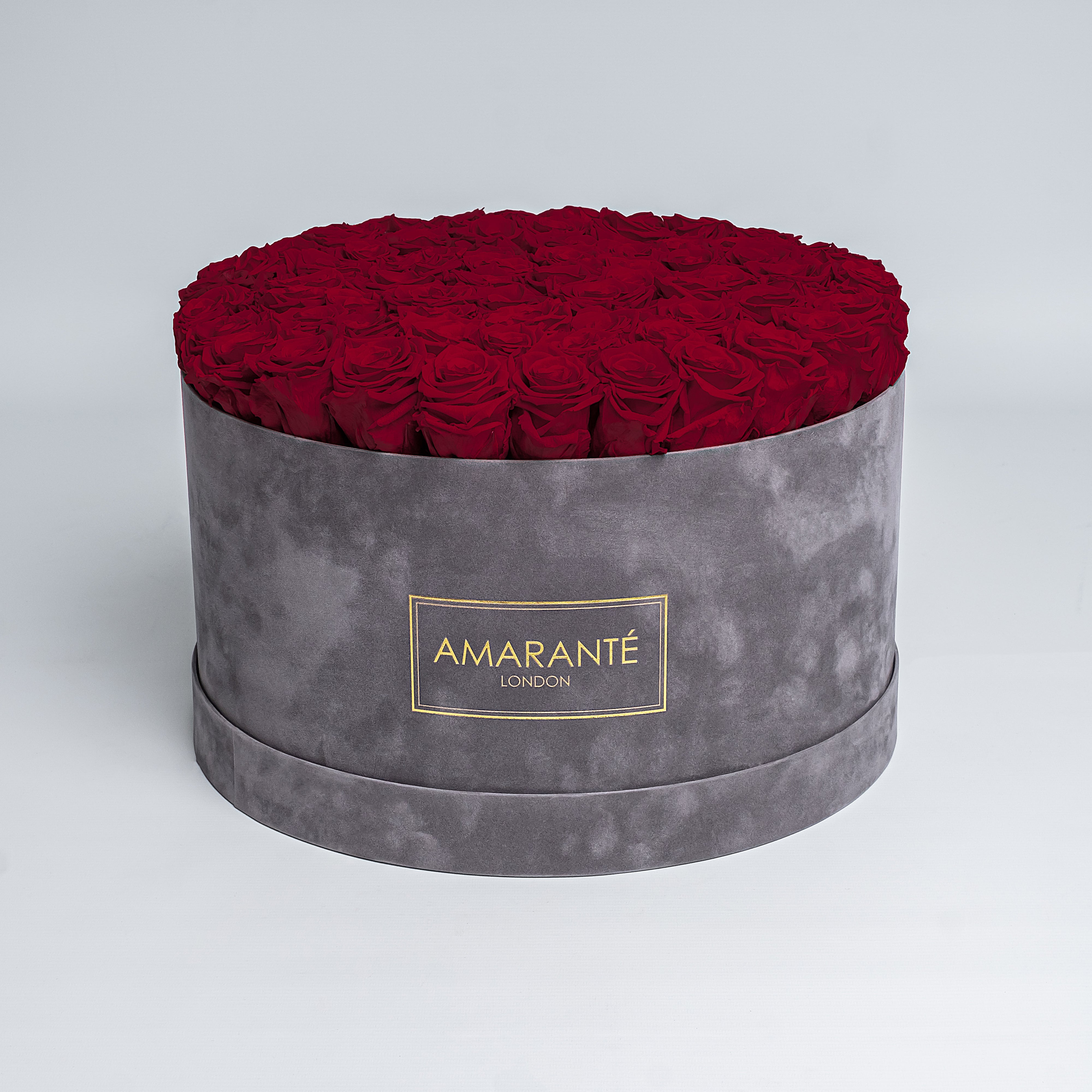 Elegant deep red Infinity Roses artistically arranged in a trendy round grey suede rose box. Free delivery in the UK. A mesmerising, luxurious gift, perfect for showing timeless love and affection to family, friends, or your significant other on Valentine's Day, Birthday, Anniversary, or other important occasion.