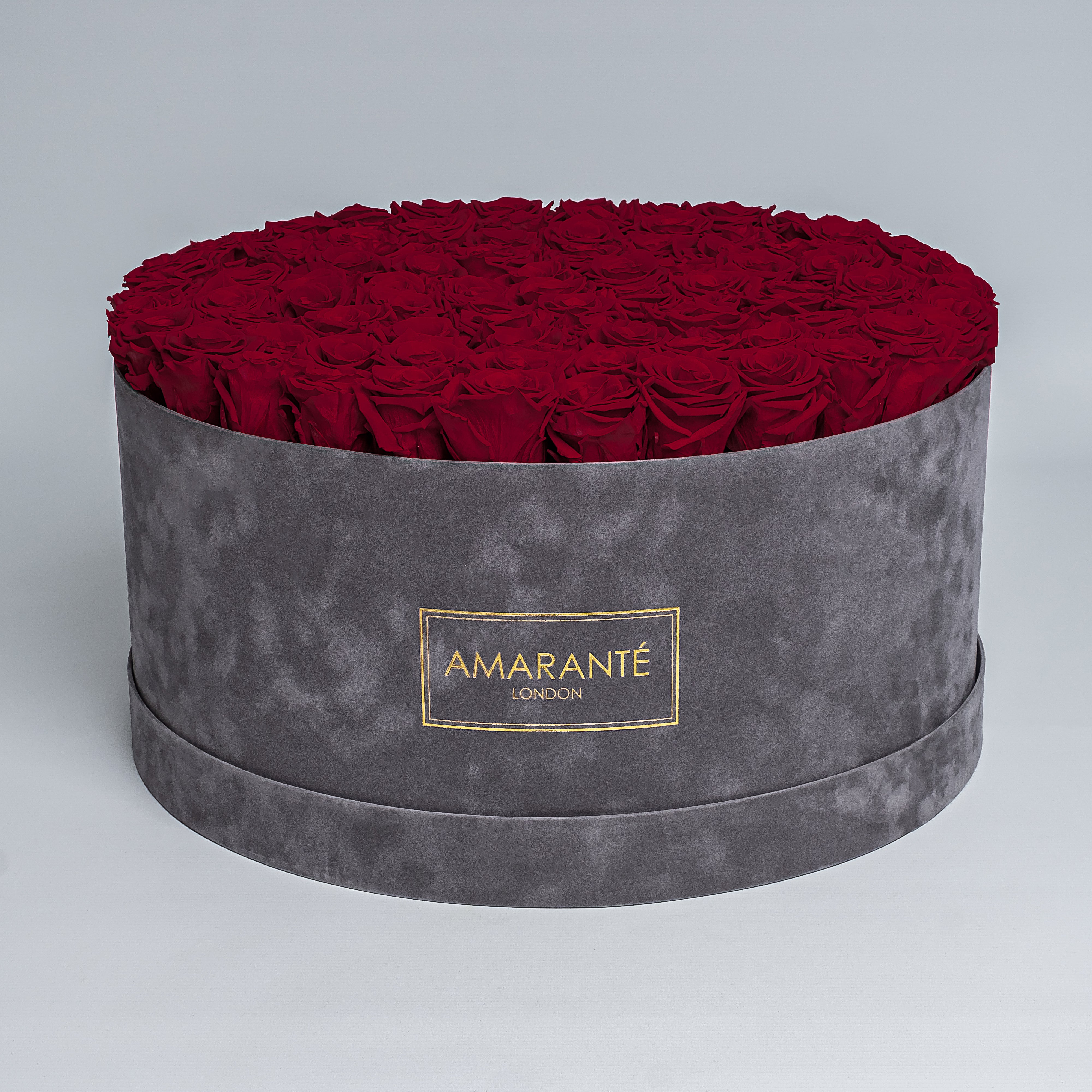 Extra Large Luxury bouquet of 100 deep red infinity roses in an elegant grey round rose box with delicate suede finish. Unique gift for showing timeless love and affection. FreeUK Delivery.