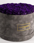 Cherished dark purple Roses in a dapper grey box, expressing luxury and magic.