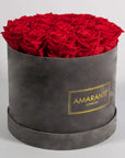 Divine red Roses in a dapper grey box, bursting with fiery colours