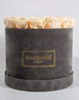Exciting champagne roses photographed in a stylish grey box