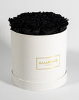 Bold black Roses shown in a dreamy white box