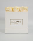 Chic champagne roses in a charming white box
