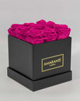Expressive hot pink roses encompassed in a stylish black box