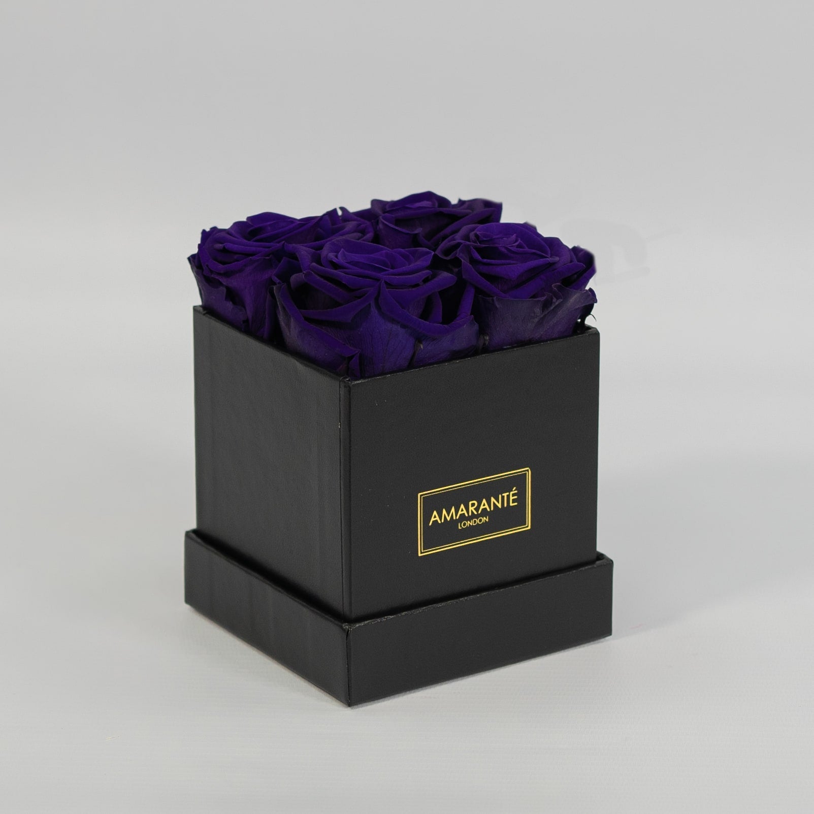 Magical dark purple roses encompassed in a stylish black box 