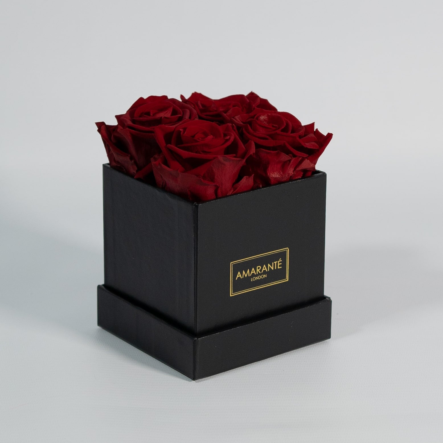 Alluring wine red roses included in a modern black box 