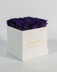 Luxurious dark purple roses included in a stunning white box