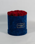 Chic wine red Roses displayed in a modish blue box
