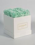 Elegant mint green roses presented in a fashionable white box