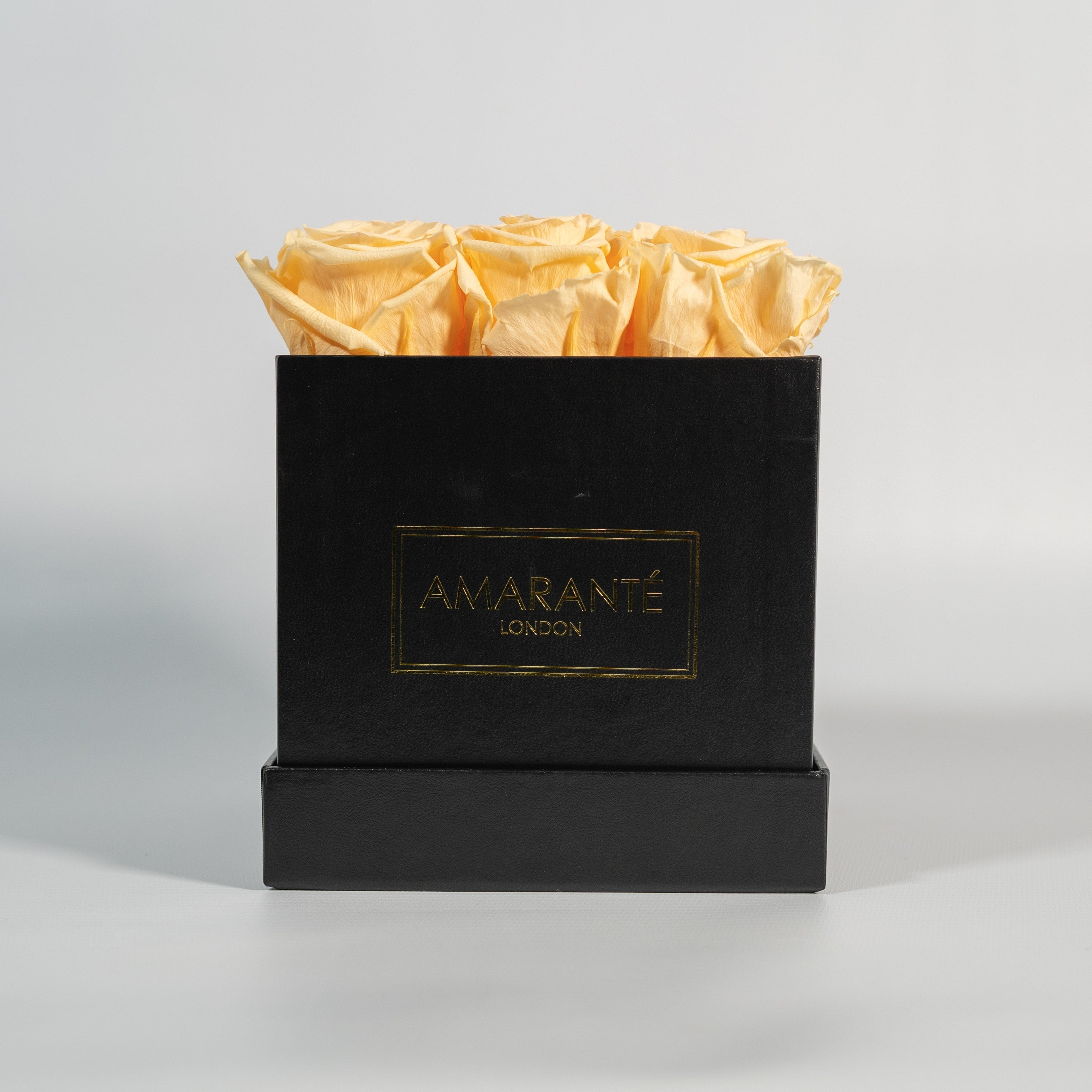 Gorgeous peach coloured roses encompassed in a trendy black box