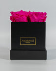Distinctive hot pink roses shown in a stylish black box