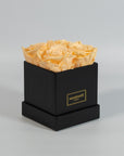Summer inspired peach roses placed in a modish black box