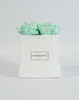 Elegant mint green roses encompassed in a modish white box