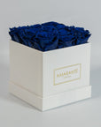 Luxurious royal blue roses indicated in a sophisticated white box
