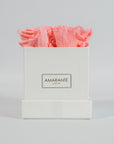 Delicate pink roses in a tender white box