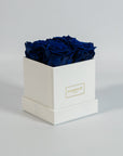 Magical royal blue roses imbedded in a charming white box