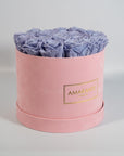 Spring time inspired lavender Roses shown in a stylish pink box