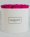 Expressive hot pink Roses featured in a dapper white box