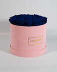 Dapper royal blue Roses in a chic pink box