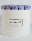 Exotic lavender Roses shown in a gorgeous white large box
