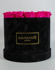 Abloom hot pink Roses in a modish black box