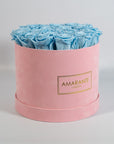 Delicate light blue Roses encompassed in a blushing pink box