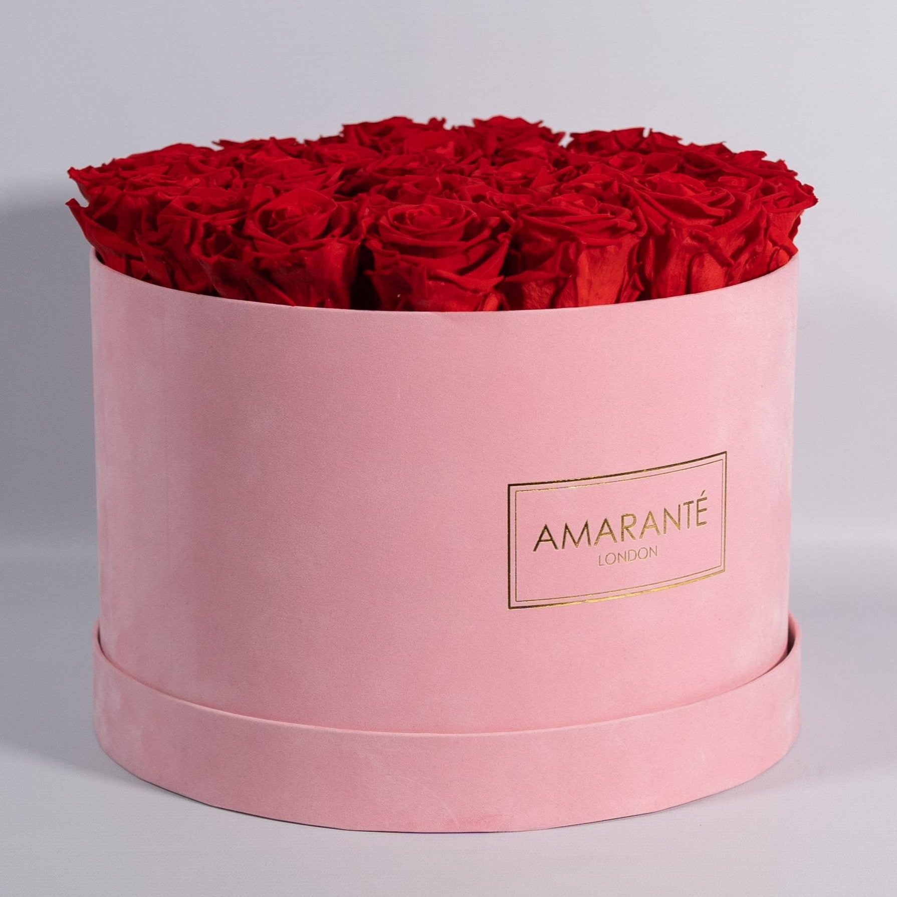 Divine red Roses shown in a magical pink suede box