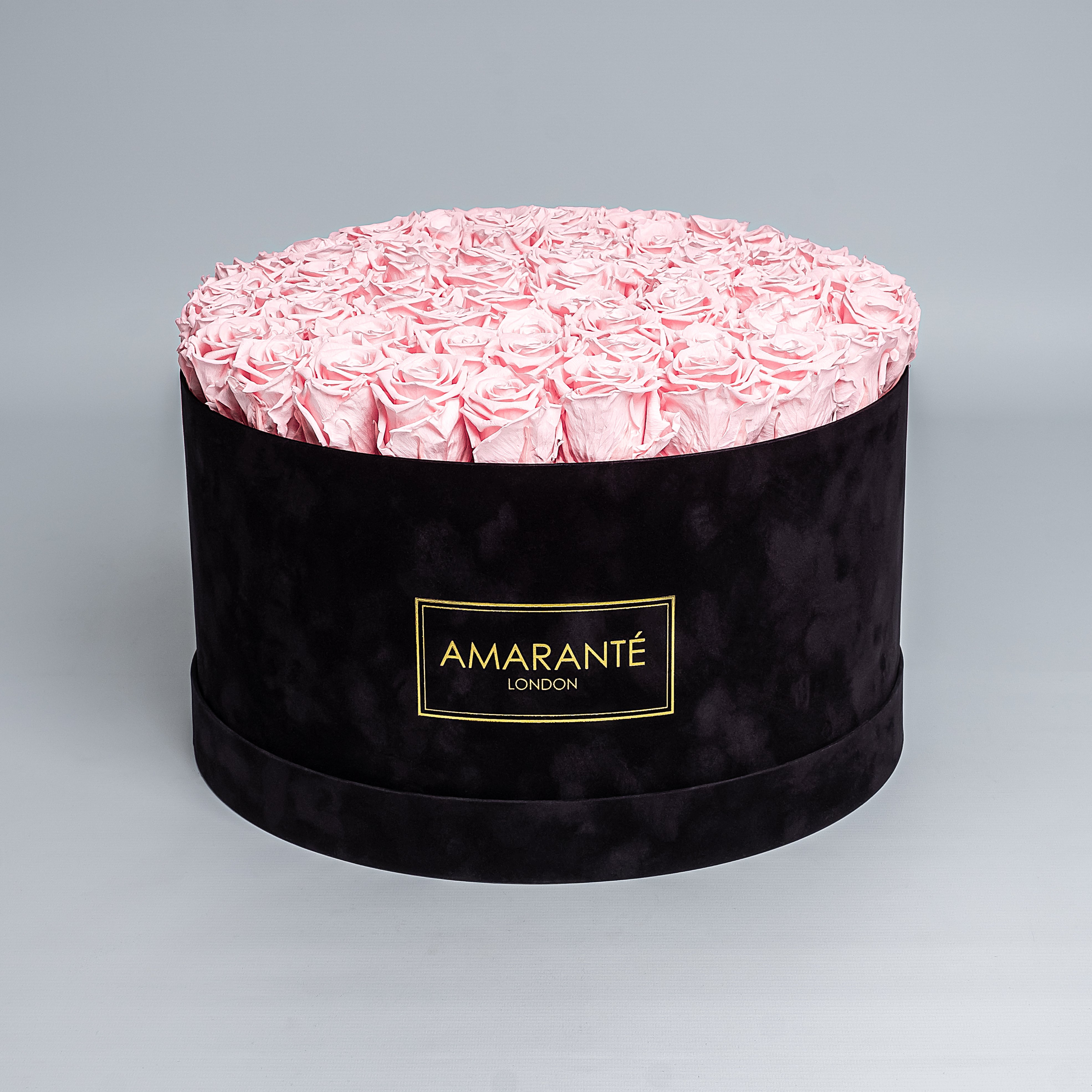 70 Exquisite light pink infinity roses elegantly arranged in a stylish black deluxe suede round rose box. Perfect for expressing timeless love and affection to family, friends and loved ones. Available for free UK delivery.
