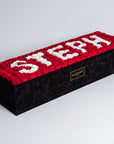 Captivating super deluxe black rectangular rose box, refined with a suede finish, housing 140 chic red and white infinity roses, symbolising enduring love with the name STEPH. Free UK delivery, Box size: 30"x25".