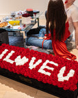 Captivating super deluxe black rectangular rose box, refined with a suede finish, housing 140 chic red and white infinity roses, symbolising enduring love with the phrase I LOVE YOU. Free UK delivery, Box size: 30"x25".