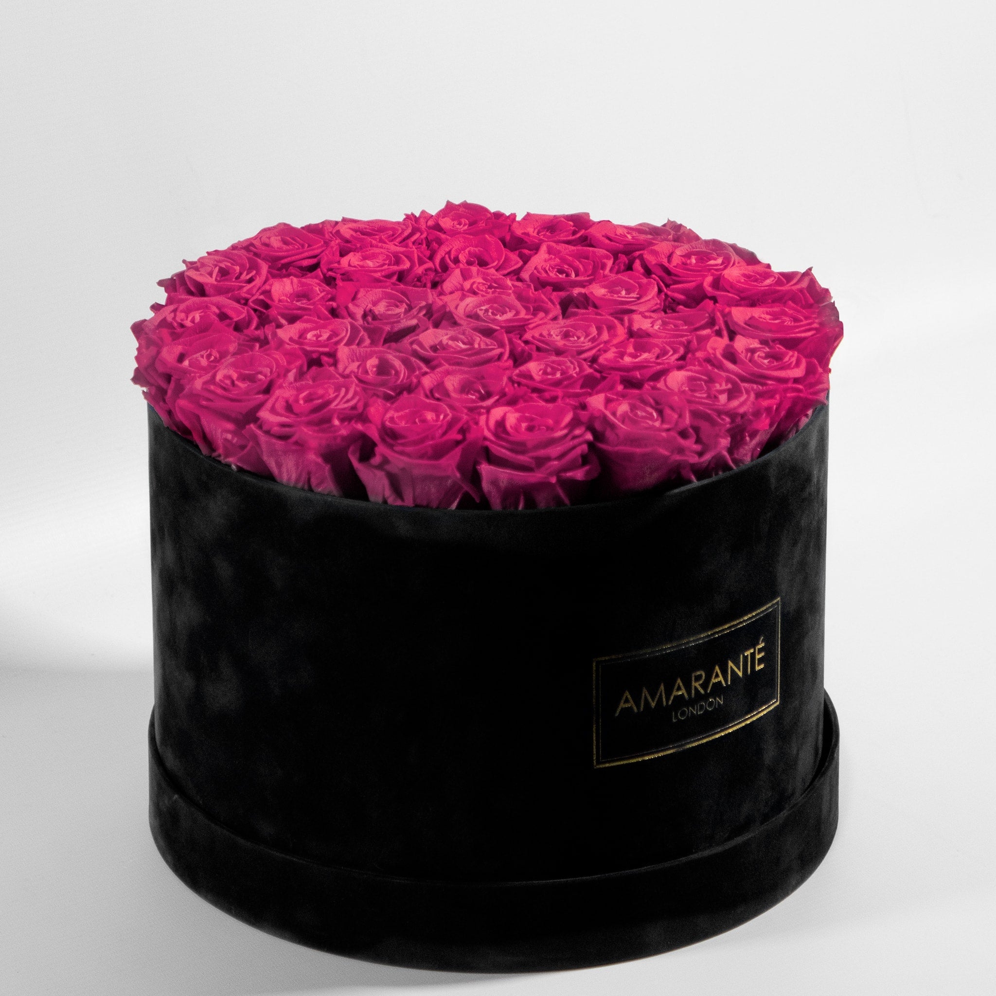 Blushing dark pink Roses in a dapper black box, the perfect way to say I love you.