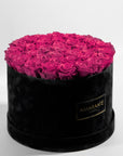 Blushing dark pink Roses in a dapper black box, the perfect way to say I love you.