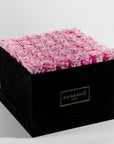 Gift of 36 enchanting pink infinity roses in a stylish black suede hatbox with Free UK Delivery.