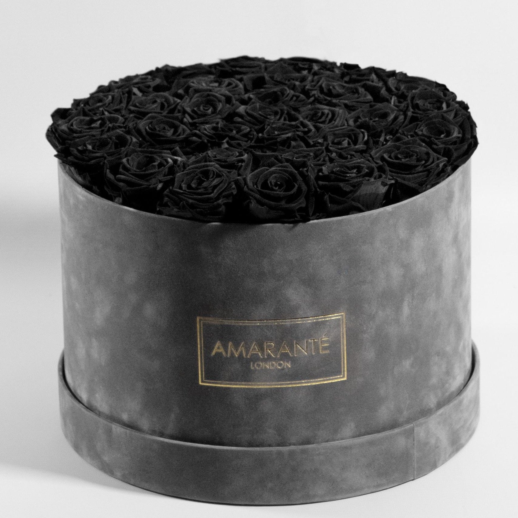 Bold black Roses in a modish grey packaging, perfect for sympathy expression