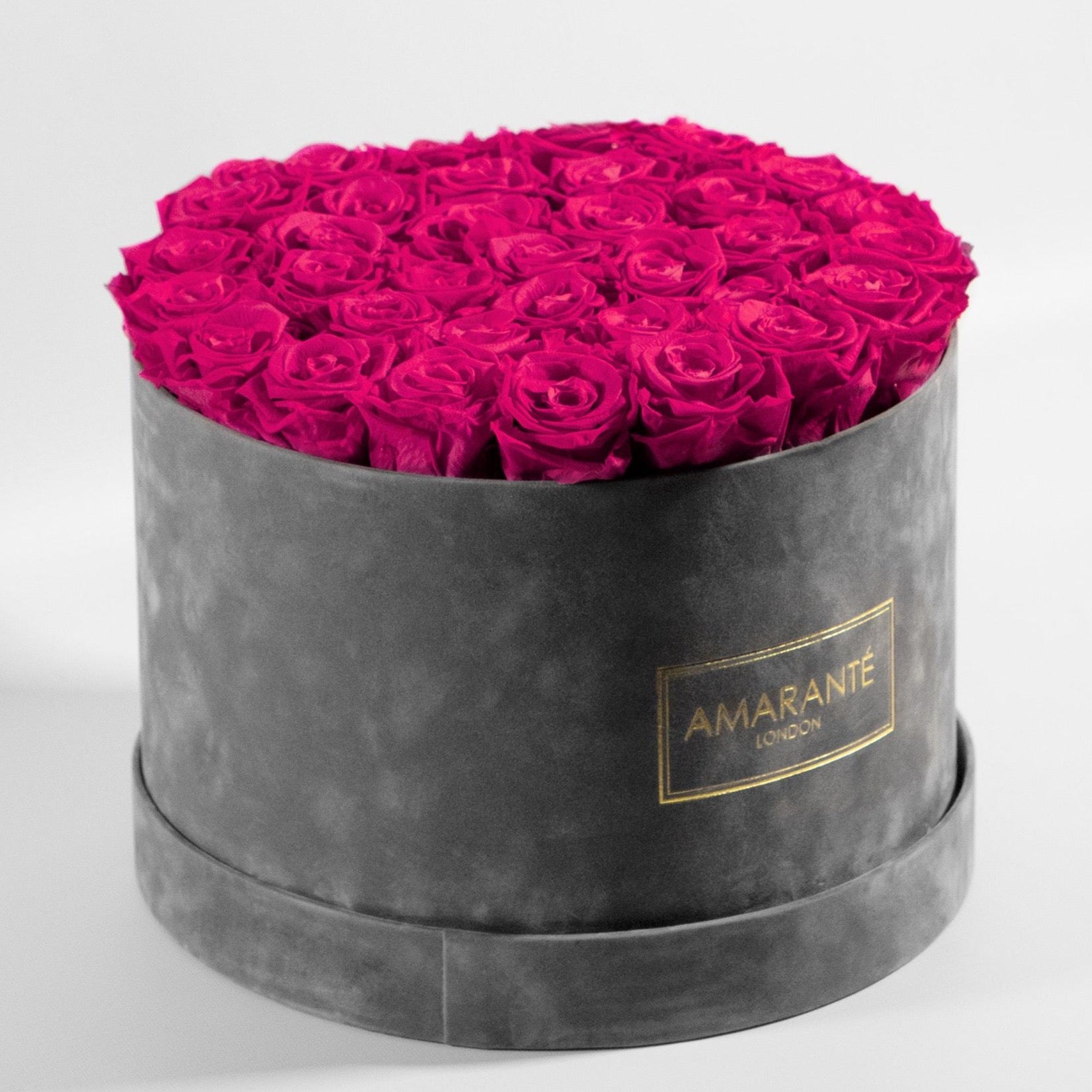 Distinctive dark pink Roses in a delicate grey box, perfect for a girlfriend