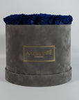 Aromatic royal blue roses presented in a modish grey box