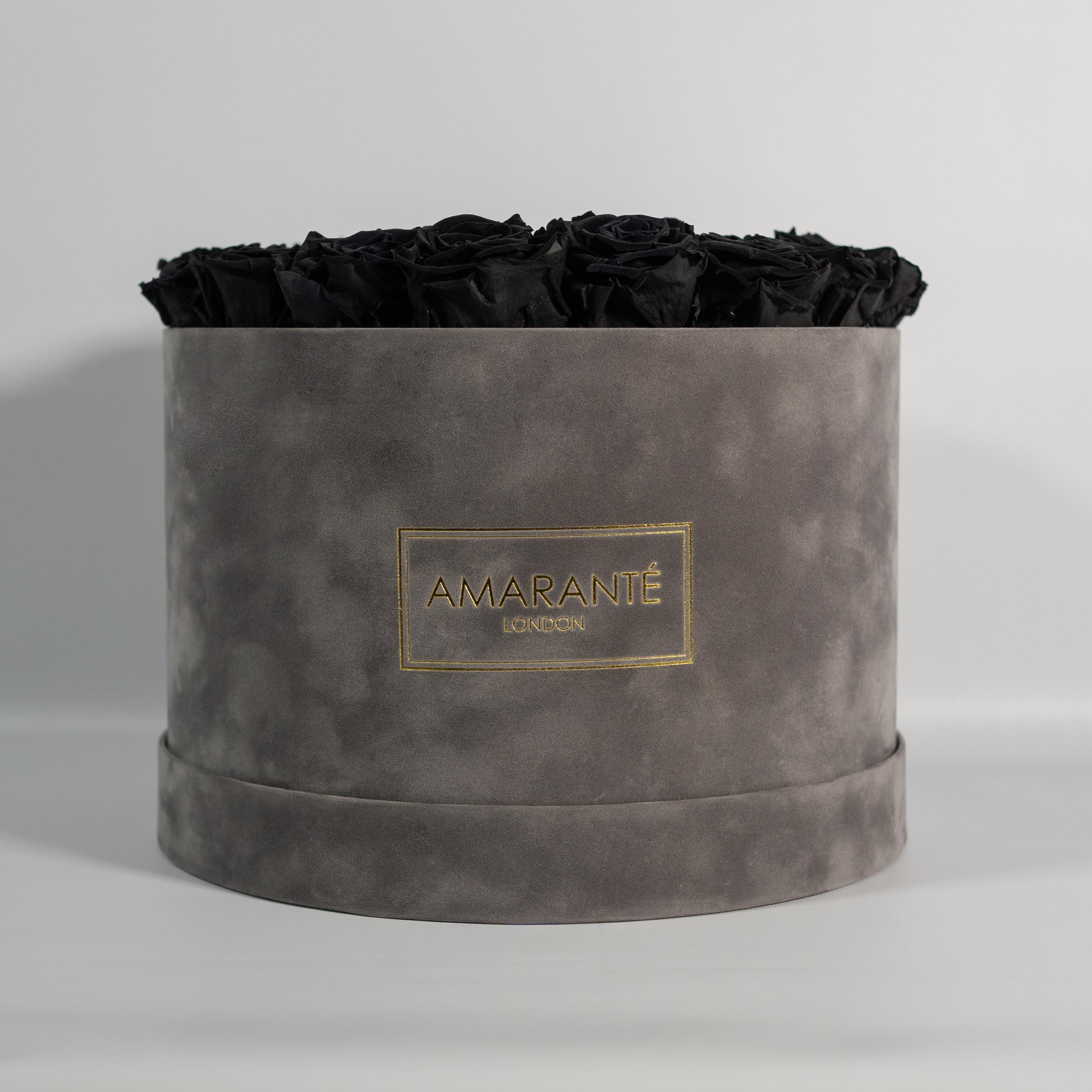 Eye catching black Roses photographed in a dreamy grey box.