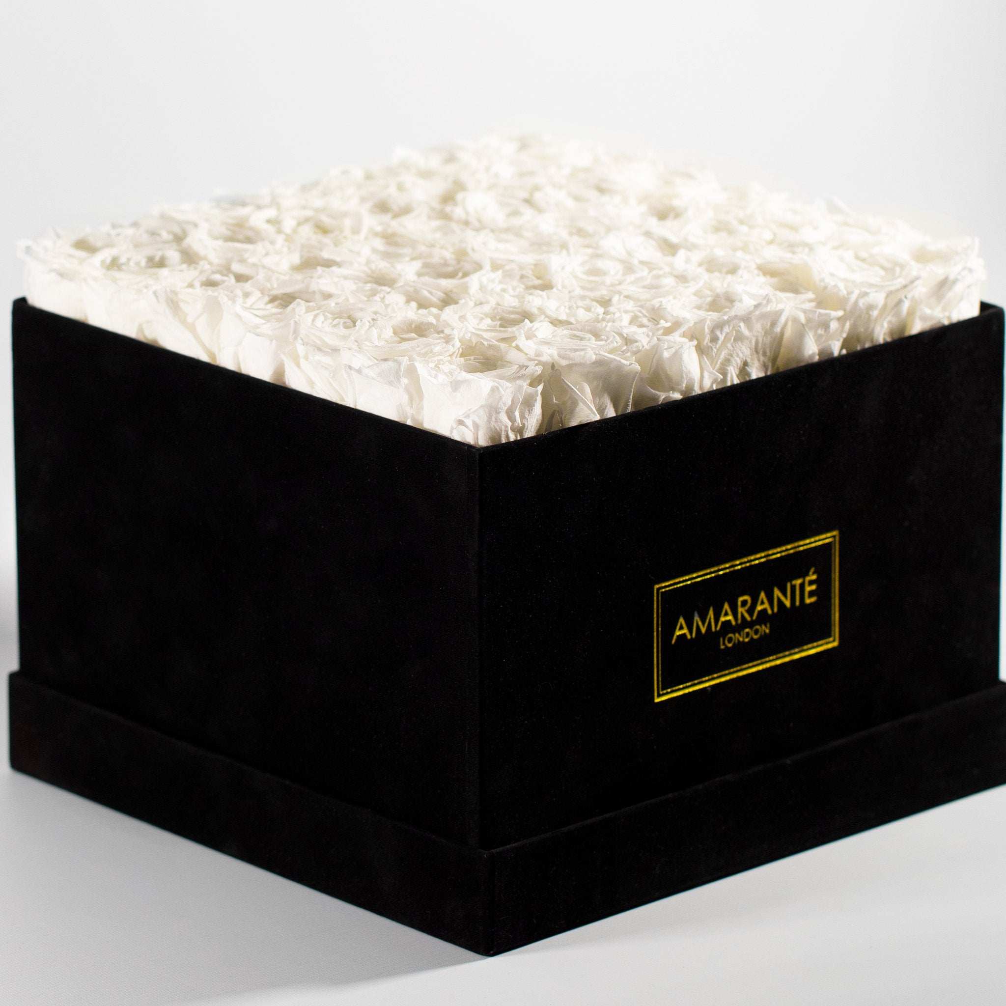 Magical white Roses in a stylish black extra large box.
