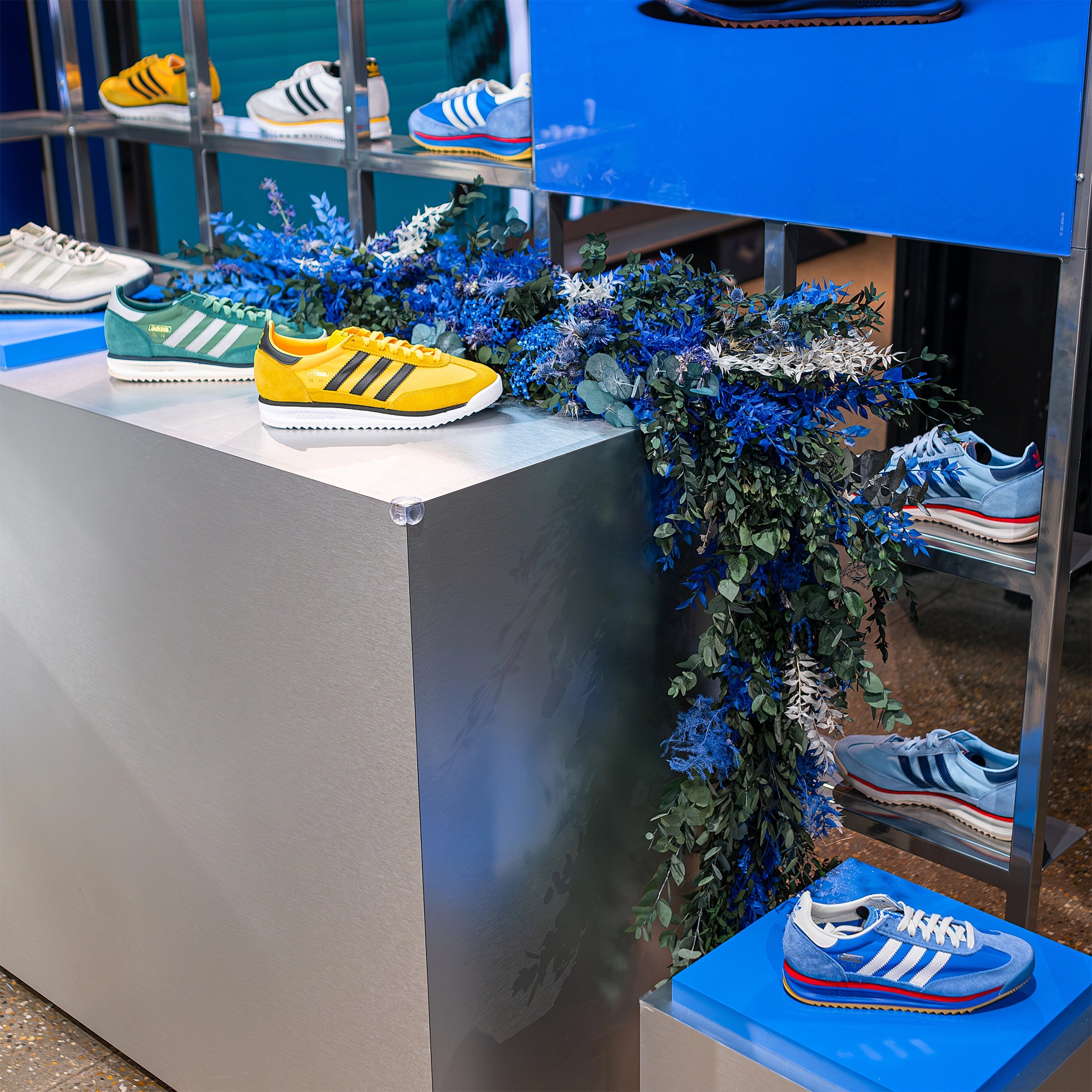 This floral installation by Event Florist Amaranté London features rich blue and green foliage to perfectly match the Adidas Bond Street store featuring the SL72 collection. This floral design reflects Adidas’ requirement for a stylish, contemporary floral design.