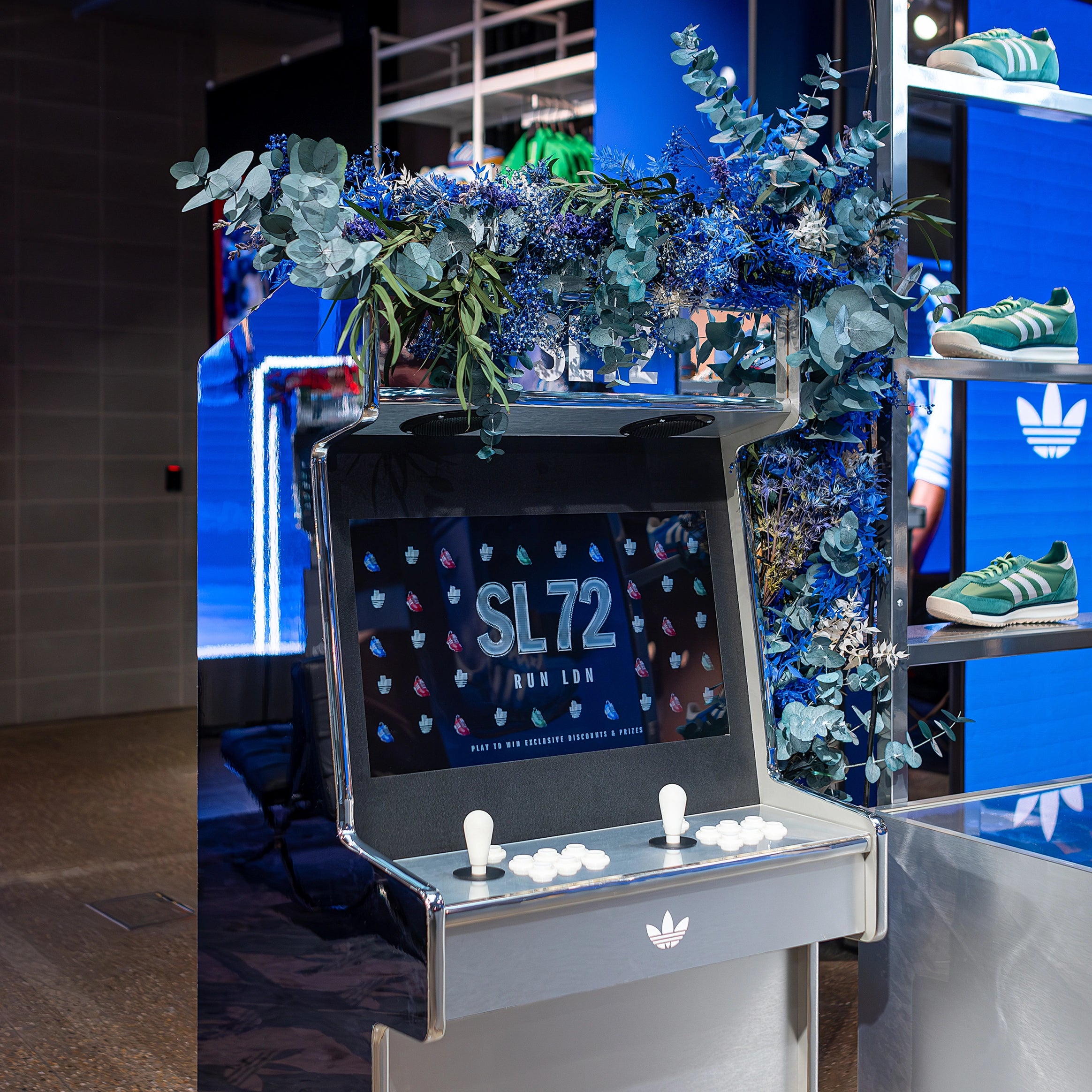 In this image, the red flowers are interwoven with green foliage for a bold visual impact. This Floral Design by Amaranté London for the Adidas Store on Bond Street was part of the SL72 launch event - luxury bespoke floral installations for stores.