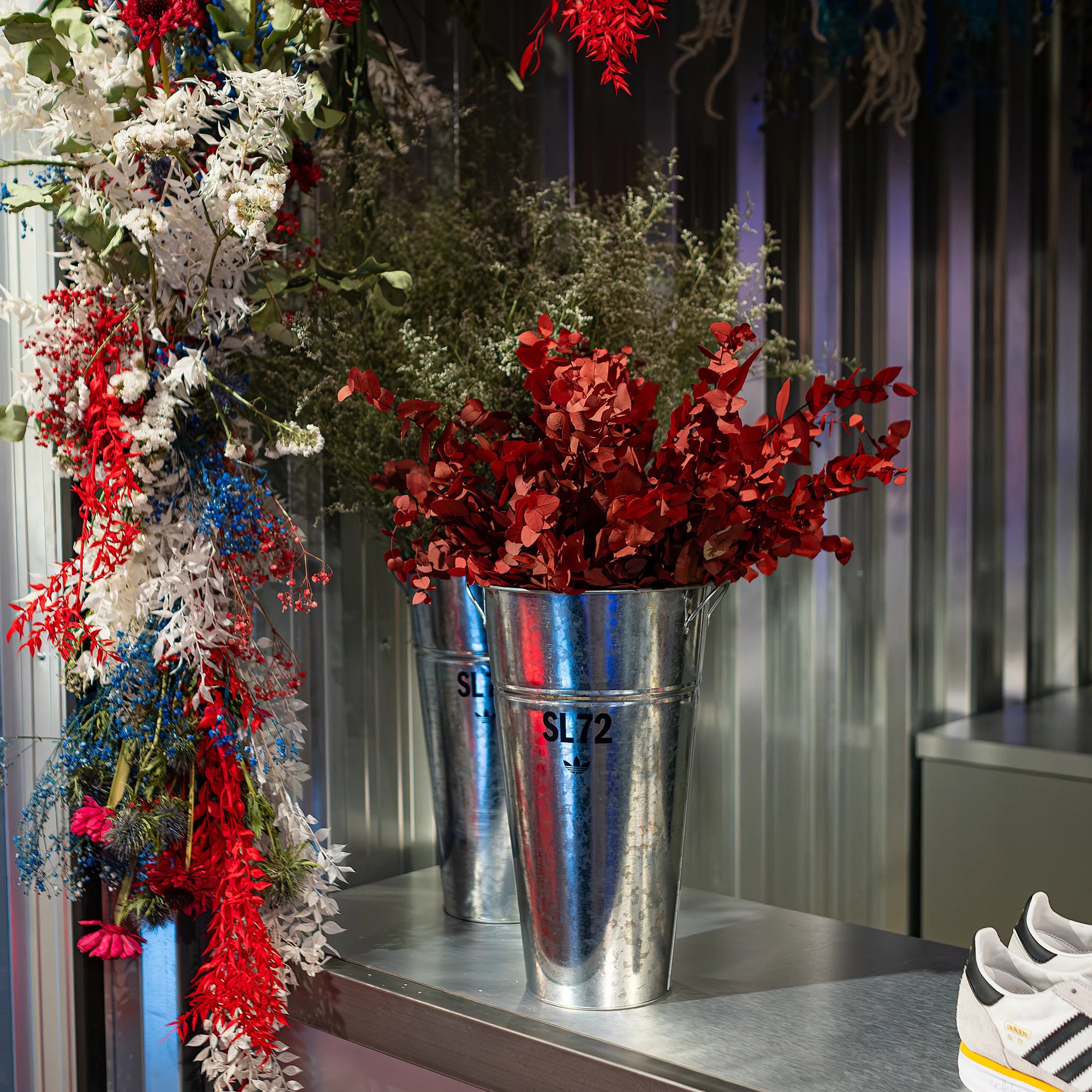 Floral arch installation positioned at the store's entry to celebrate the launch of a new shoe collection, a custom floral arrangement to welcome shoppers into the store - Amaranté London, Event Florist.