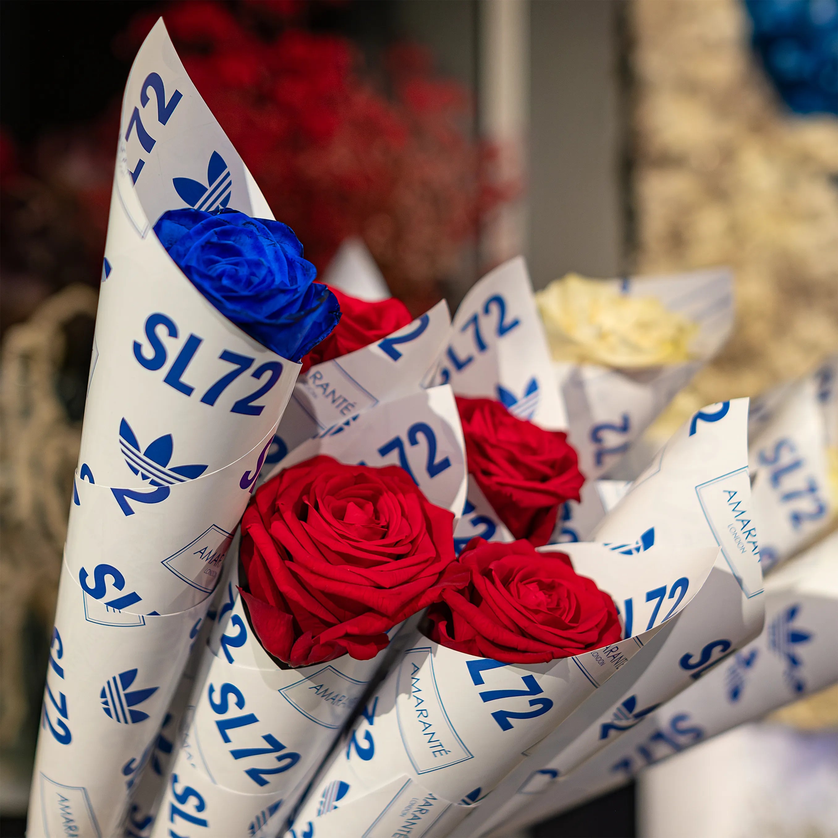 Single infinity roses in red, blue, and white, wrapped in SL72 branding at Adidas' Oxford Street Store - Amaranté London