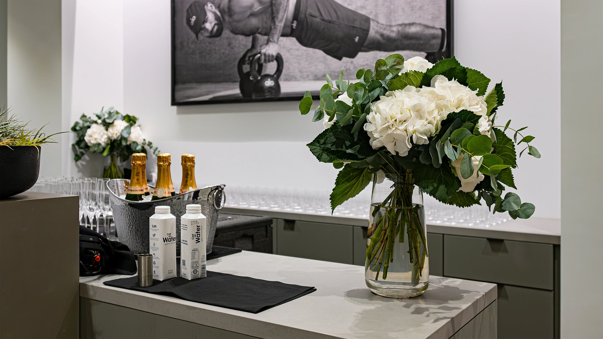 A tropical plant arch made from a mix of Monstera, Birds of Paradise, and Kentia palms, designed, created and installed by Event Florist Amaranté London at the Alo Regent Street Store Grand Opening.